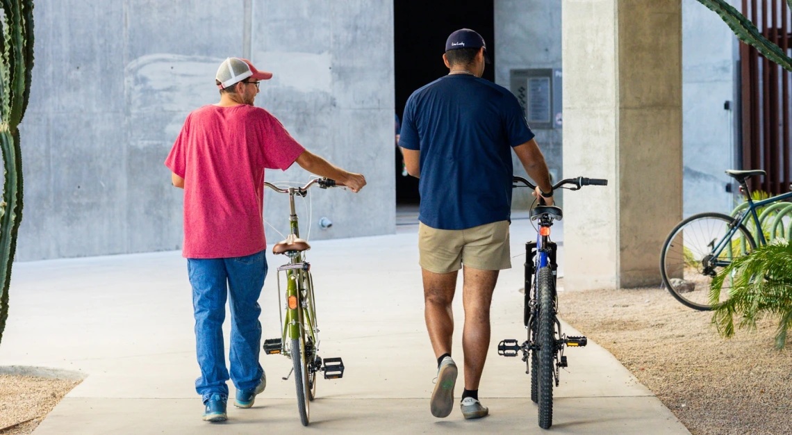 people walking away with bikes